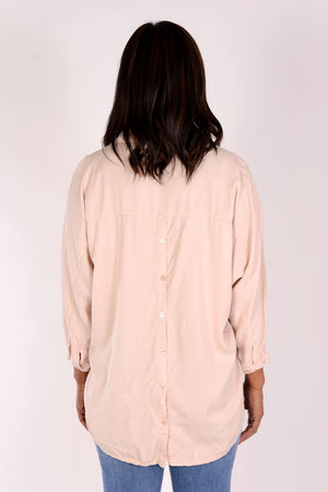 Suzy D Bonny Button Back Top in pale Pink. Pointed collar split v shirt with center seam. Dolman 3/4 sleeve with button cuff. Soft side gathers. Back yoke with button detail down center back. High low hem. Slightly oversized fit._34236644589768