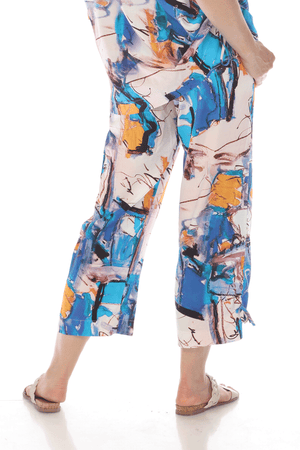 Terra Abstract Art Ankle Pant.  Shades of blue and orange abstract watercolor print.  Elastic waistband pull on pant with front slash pockets.  Straight leg with cinch ties at outside lower leg.  Side slits. Inseam: 26 1/2"_59705873957230
