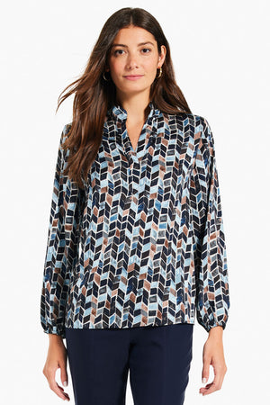 NIC+ZOE Herringbone Blues Top.  Retro vintage herringbone inspired print in shades of blues and tan.  Stand collar with split v placket.  Slightly puffed sleeve with elastic cuff.  Straight hem. Relaxed fit._34631288324296
