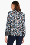 NIC+ZOE Herringbone Blues Top. Retro vintage herringbone inspired print in shades of blues and tan. Stand collar with split v placket. Slightly puffed sleeve with elastic cuff. Straight hem. Relaxed fit._t_34631288291528