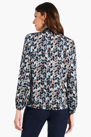 NIC+ZOE Herringbone Blues Top. Retro vintage herringbone inspired print in shades of blues and tan. Stand collar with split v placket. Slightly puffed sleeve with elastic cuff. Straight hem. Relaxed fit._34631288291528