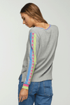 Zaket & Plover Jacquard Sleeve Sweater in Marled Gray. V neck sweater with long sleeves. Color block stripe and block print on center sleeve. Striped trim at neck and cuff. Ribbed at neck, cuff and hem. Side slits. Relaxed fit._t_34536815788232