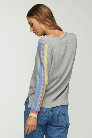 Zaket & Plover Jacquard Sleeve Sweater in Marled Gray. V neck sweater with long sleeves. Color block stripe and block print on center sleeve. Striped trim at neck and cuff. Ribbed at neck, cuff and hem. Side slits. Relaxed fit._34536815788232