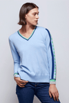 Zaket & Plover Jacquard Sleeve Sweater in Sky blue. V neck sweater with long sleeves. Color block stripe and block print on center sleeve. Striped trim at neck and cuff. Ribbed at neck, cuff and hem. Side slits. Relaxed fit._t_34536815853768