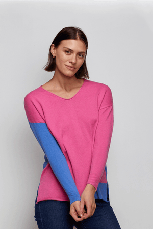 Zaket & Plover Two Tone Sweater in Bright Pink. V neck drop shoulder sweater. Color blocked with bright blue front to back. Single blue sleeve. Blue inset at left hem. Side slits. Rib trim at cuff and back hem. Rolled edge at neckline and front hem. Relaxed fit._34536885518536