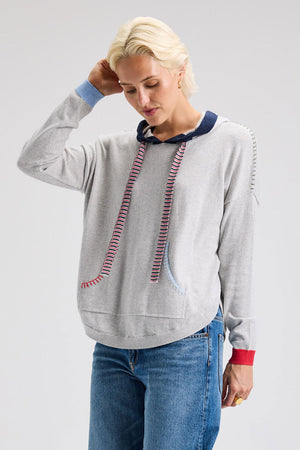 Zaket & Plover Joey Pocket Hoodie in Marled.  Heather gray pullover cotton/cashmere hoodie with contrast trim on hood and striped drawstring.  Long sleeves with contrast colored ribbed cuffs.  Front pouch pocket.  Blanket stitch trim at shoulders and pocket opening.  Curved hem with ribbing.  Relaxed fit._61025051902318