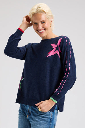 Zaket & Plover Threaded Star Sweater in Dark Denim.  Boatneck dolman long sleeve knit.  2 intarsia and embroidered stars on front.  Contrast color threaded double rows of stitching down each sleeve.  Plain back.  Rib trim at neck and cuff.  Side slits.  Relaxed fit._61395590906222