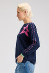 Zaket & Plover Threaded Star Sweater in Dark Denim.  Boatneck dolman long sleeve knit.  2 intarsia and embroidered stars on front.  Contrast color threaded double rows of stitching down each sleeve.  Plain back.  Rib trim at neck and cuff.  Side slits.  Relaxed fit._t_61395590938990