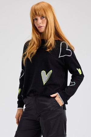 Zaket & Plover Intarsia Heart Sweater in Black.  Boat neck long sleeved. sweater with multi-color, multi-sized intarsia hearts on front and sleeves.  Plain back.  Rib trim at cuff and hem.  Contrast color trim at cuff.  Side slits. Relaxed fit._61457766941038