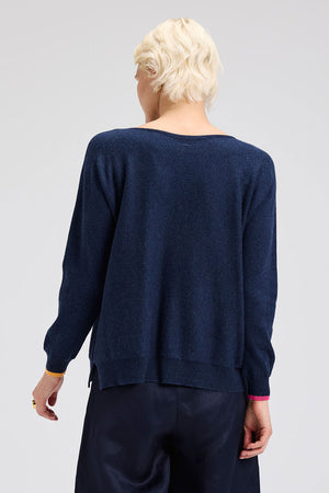 Zaket & Plover Intarsia Heart Sweater in Dark Denim.  Boat neck long sleeved. sweater with multi-color, multi-sized intarsia hearts on front and sleeves.  Plain back.  Rib trim at cuff and hem.  Contrast color trim at cuff.  Side slits. Relaxed fit._61457767039342