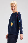 Zaket & Plover Intarsia Heart Sweater in Dark Denim.  Boat neck long sleeved. sweater with multi-color, multi-sized intarsia hearts on front and sleeves.  Plain back.  Rib trim at cuff and hem.  Contrast color trim at cuff.  Side slits. Relaxed fit._t_61457767072110