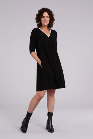 Sympli Tipped Reversible Trapeze Dress in Black. V neck or crew neck front or back? It's your choice! A line relaxed fit dress with 3/4 sleeves. Ivory contrast color tipping at neckline and cuff. In seam pockets._34438205898952