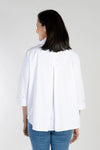 Cali Girls Swing Blouse in White. Popover blouse with wide pointed collar and split v neck. 3/4 sleeve with split cuff. Center front slit. Single oversized front pocket. Back inverted pleat. High low hem. Relaxed fit._t_34092565725384