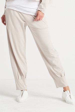 Planet Pinched Pleat Pant in Putty. Elastic waist pull on pant with draped lantern style leg with pinched pleats to cinch at hem. 2 Side seam pockets. Relaxed fit._34035368952008
