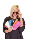 Blonde woman wearing sunglasses looking a different colored eyeglass cases_t_8680996700258