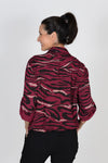 Cali Girls Animal Print Top in Berry/Black. Zebra print in black and gold metallic on berry red background. Pointed collar button down shirt with rope drawstring at hem. Bracelet length sleeve with button roll tab. Relaxed fit._t_33425961025736