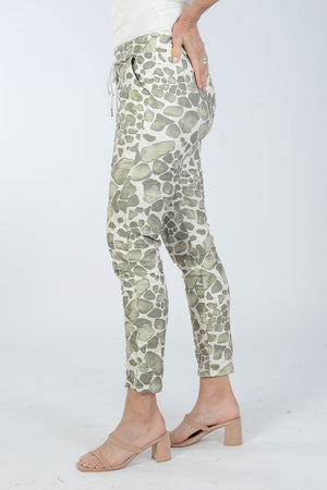Organic Rags Spots Pant. Stylized animal print in Khaki on a white and beige background. Elastic waist pull on pant with metallic drawstring. 2 front slash pockets. Stretch crinkle fabric. Back pointed yoke detail. Convertible hem. Inseam: 27 1/2"_34011793916104