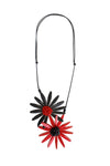 The Floral Statement Necklace is a wearable piece of art! This sculptural and unique necklace features two handcrafted wooden flowers in black and red with clusters of tiny beads in the centers in corresponding colors adding dimension to these artful pendants. _t_33973397487816