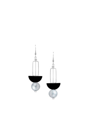 The Atmospheric Orbs Dangle Earrings are a modern and chic pair of dangle earrings each showcasing a sculptural stack of a luminous gray pearl, a black wooden half circle bead, and an open silver rectangle hanging from a standard hypoallergenic surgical steel fishhook earring wire._33053452697800
