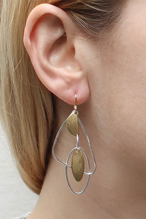 Large open silver colored organic shapes accented by golden geometric charms dangling from a standard wire earring fish hook._32610004435144