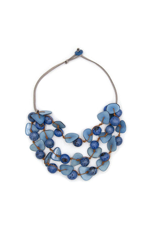 A stylish earth-friendly statement necklace featuring 3 strands of hand-carved beads in various shapes and sizes made from tagua nuts, bombona seeds, and acai berries on an suede cord with button and loop closure. _33405707780296