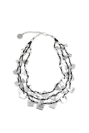 Short Square Chips Necklace in Silver. Silver plated pewter chips in triple strand on black cord. Hook closure. Adjustable._32524741411016