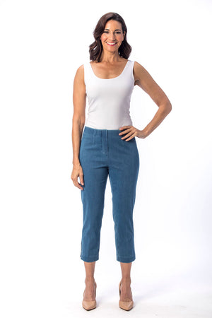 Holland Ave Susan Denim Crop Pant in Vintage Blue. Pull on hidden waistband pant with faux zipper flap. Snug through hip falls straight to hem. Side slits. 25" inseam._13120006553698