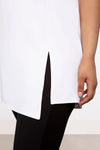 Sympli Sleeveless Mock Neck Slit Tunic in White. Mock neck long top with asymmetric front hem. Off side wrapped seam with slit. Relaxed fit. Tunic length._t_34038761357512