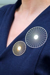 Catch some rays with this unique and graphic solar brooch. These cool pins are lightweight and attach with a magnetic rubber button leaving no damage to your clothes!_t_33359097364680